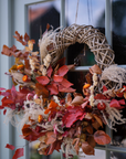 Autumn Wreath with orange foliage on front door.