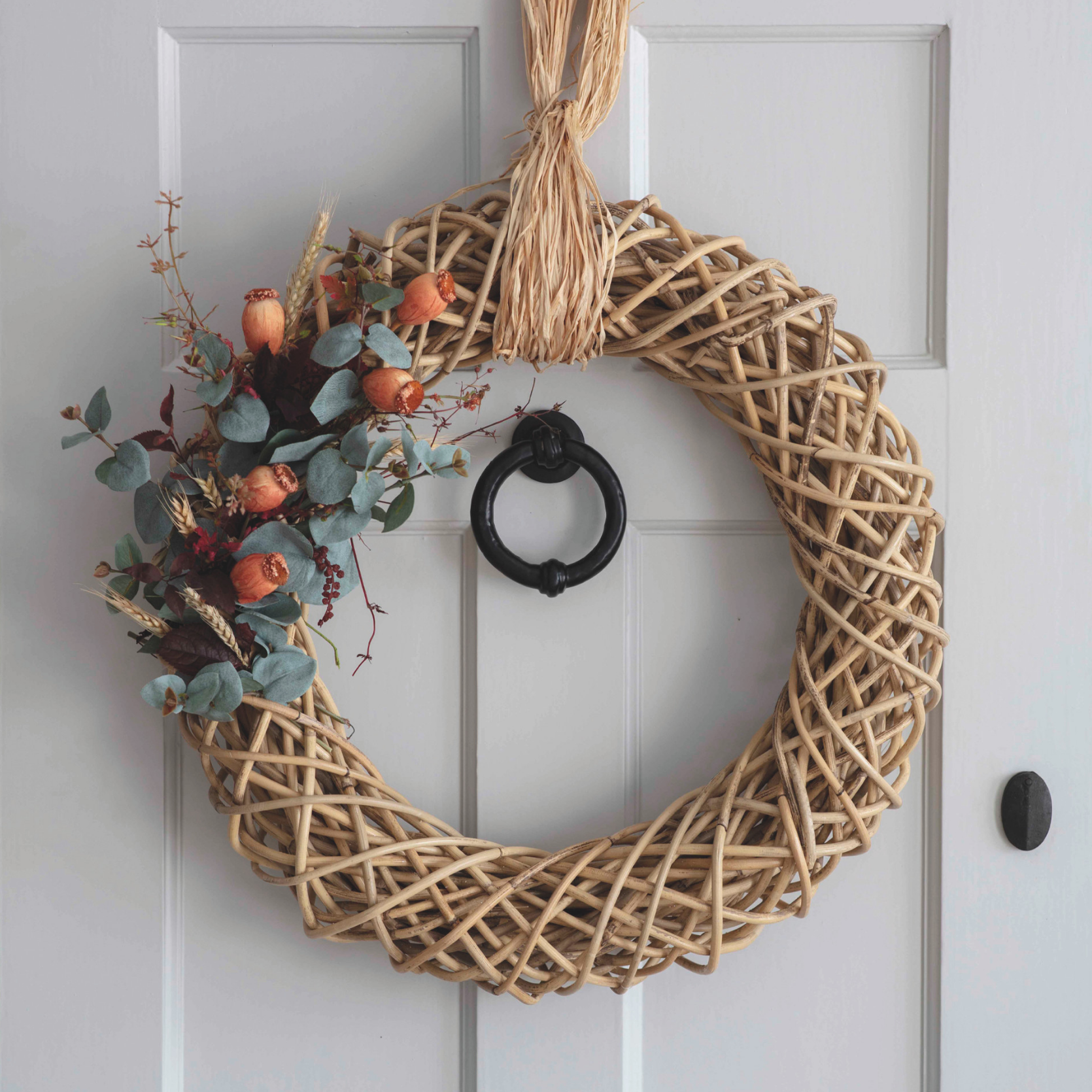 Autumn Wreath with orange foliage on front door.