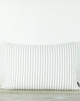 A white and taupe striped cushion.