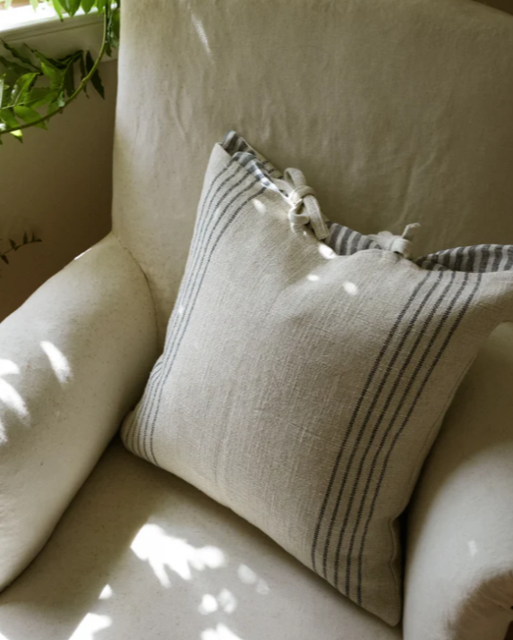 Cream and blue striped cushion on cream sofa.