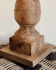 Square base of wooden table lamp on wicker basket able.