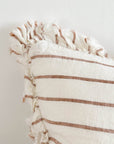 Close up of cream and brown striped ruffle linen cushion.