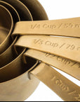 brass measuring cups embossed with measurements. 