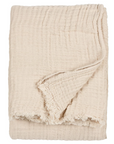 Natural cream crinkle cotton throw folded up with the side turned up.