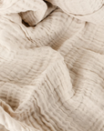 Close up of natural cream crinkle cotton throw.