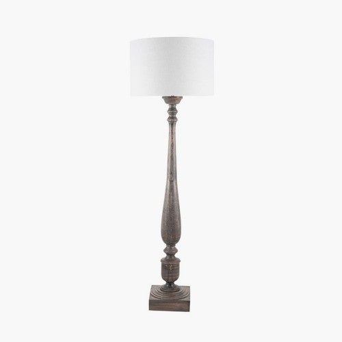 Tall brown column floor lamp base with square base and turns, with white lamp shade.