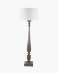 Tall brown column floor lamp base with square base and turns, with white lamp shade.