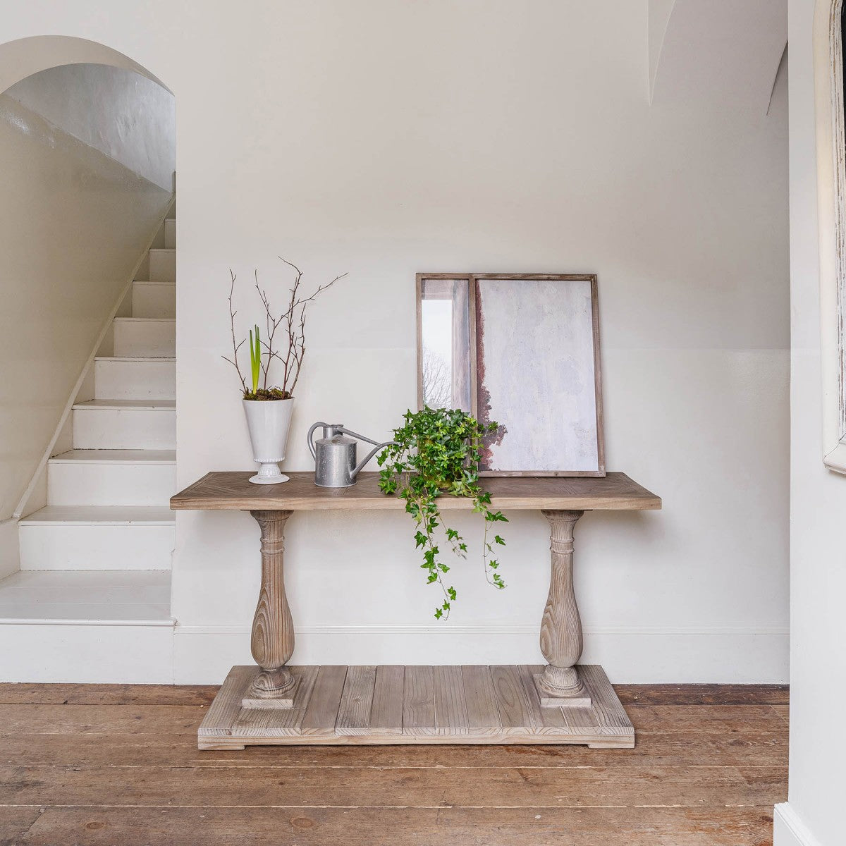 Lilibet Reclaimed Wooden Console Table with plant and watering can.