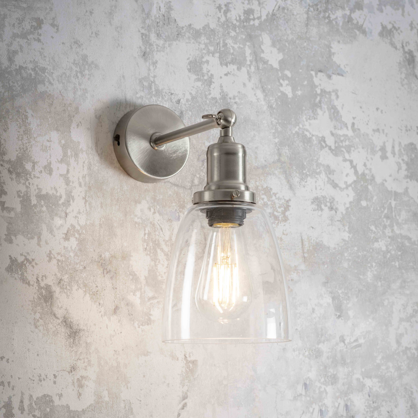 Silver wall light with glass shade.