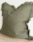 Green cushion will ruffled frayed edge.