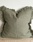 Green cushion will ruffled frayed edge.