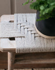 The rope detail on the Lulworth Rustic Wooden Side Table, with a plant in a black ceramic pot.