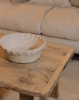 Large Terracotta Planter with a Pie Crust Rim on coffee table.