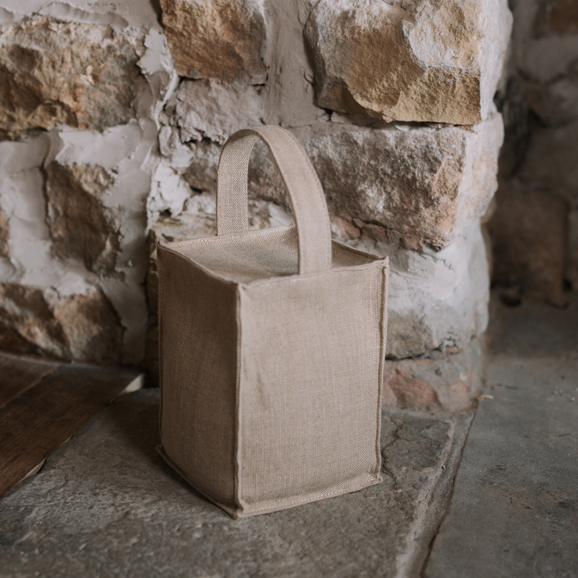 Natural linen doorstop with handle on stone hearth.