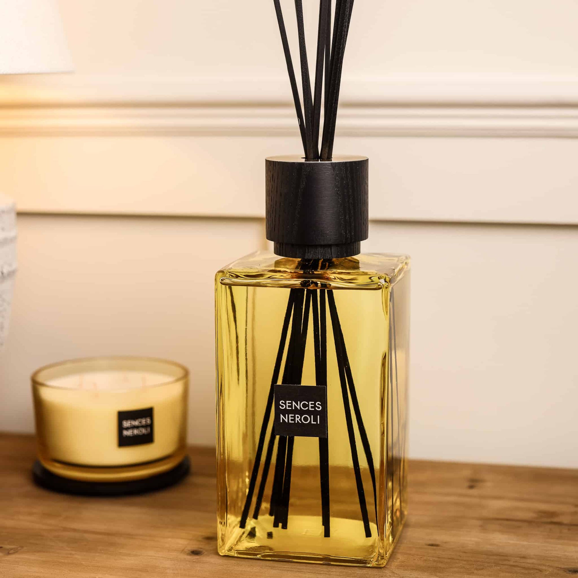 Sences Neroli Extra Large Reed Diffuser on wooden console with matching candle.