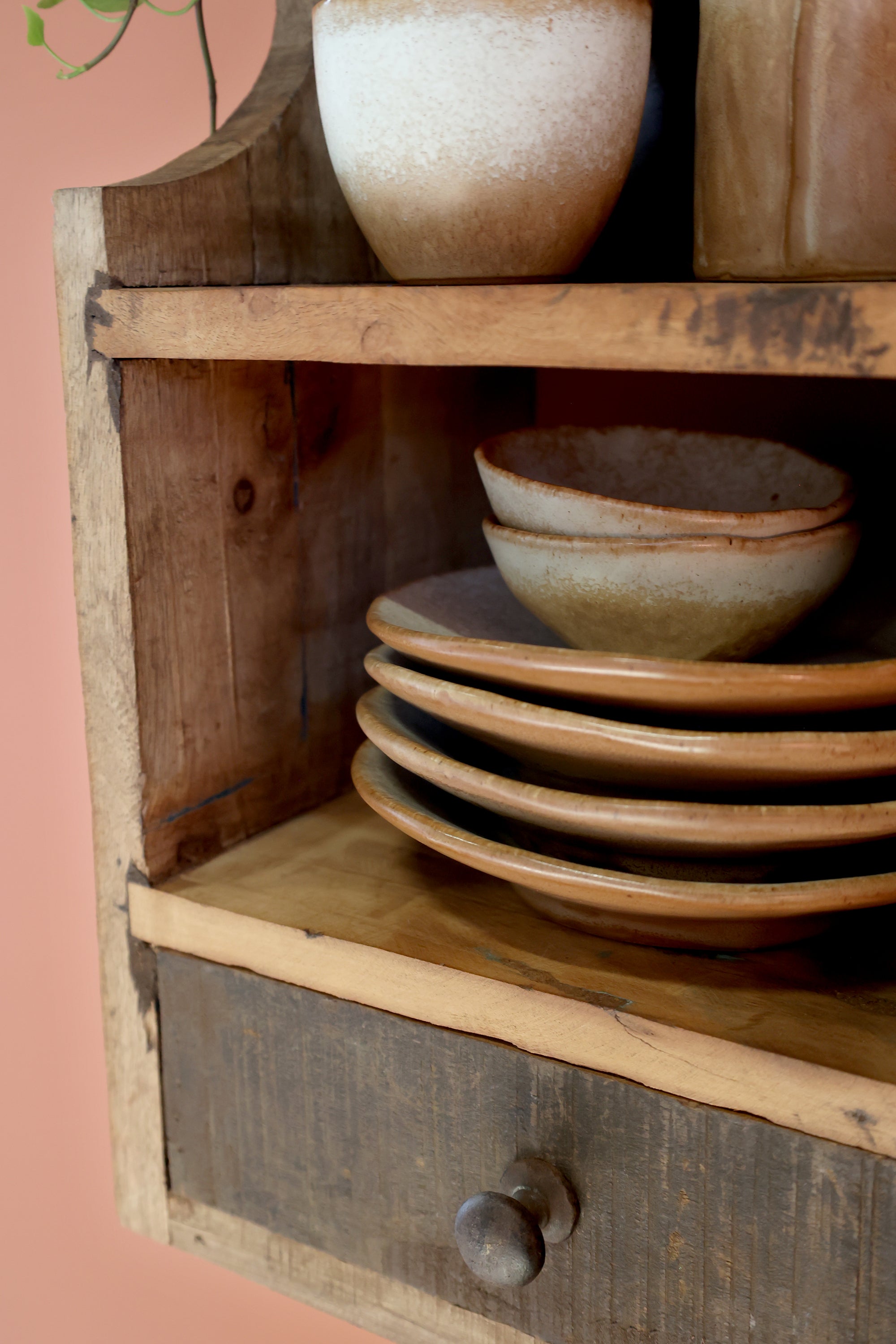 Close up of natural grain on small wooden shelf with drawer.