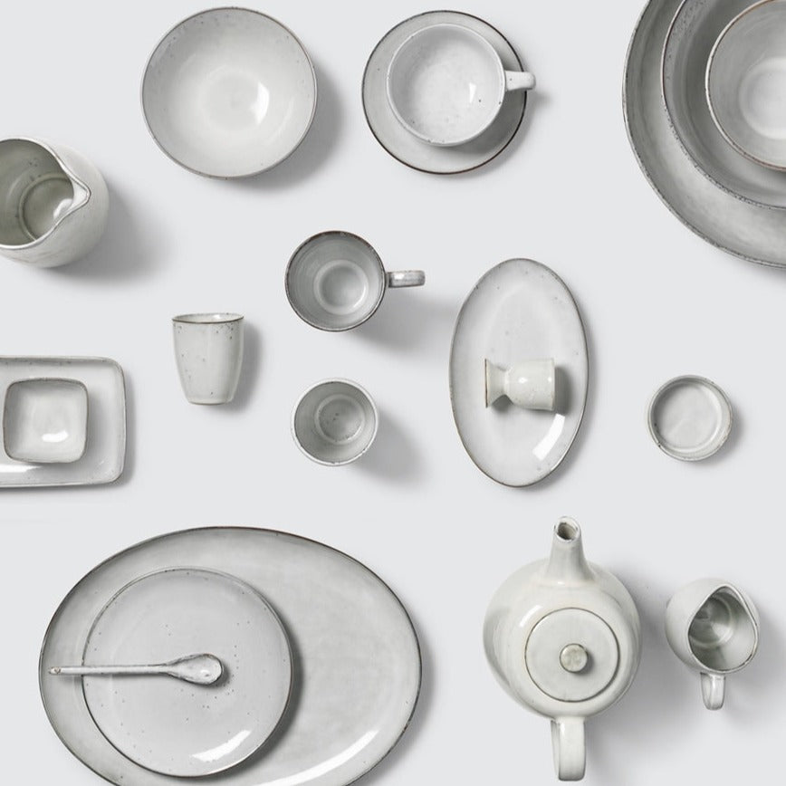 Full off white speckled dinnerware collection.