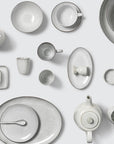 Full off white speckled dinnerware collection.