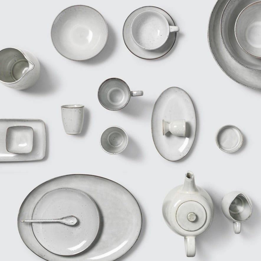 Off white speckle glazed full dinnerware collection.