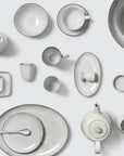 Full of white speckled dinnerware collection.