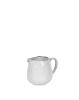 Off white speckle glaze milk jug from spout view.