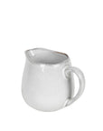 Off white speckle glazed jug from handle view.