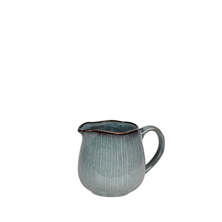 Blue glazed milk jug with handle.