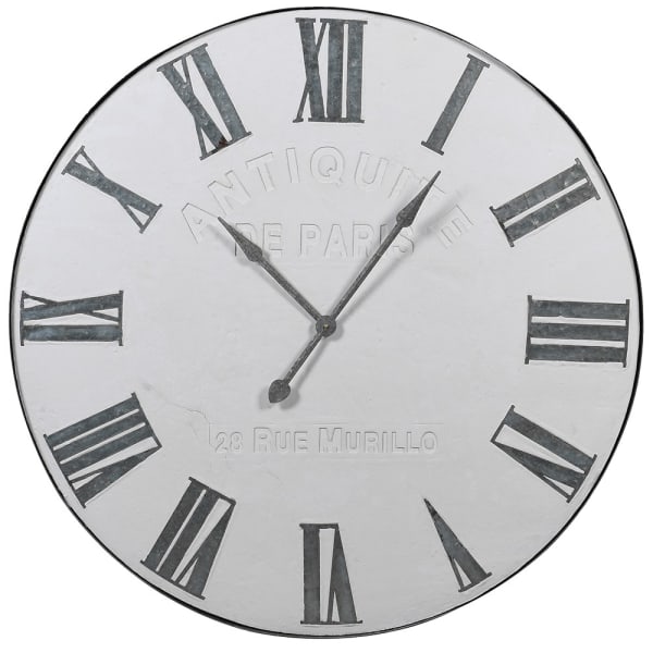 Large wall clock with white face, and iron engraved roman numerals.