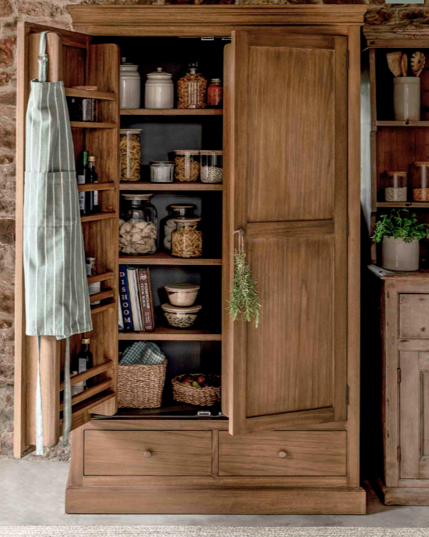 Wooden Pantry Cupboard filled with jars of dried goods and a kitchen apron hanging on the door.