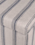 Close up of fabric on blue striped large ottoman with handle.