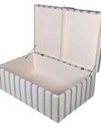 Blue striped large ottoman with handle open with white lined inside.