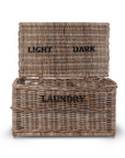 Rattan laundry basket with light and dark labels.