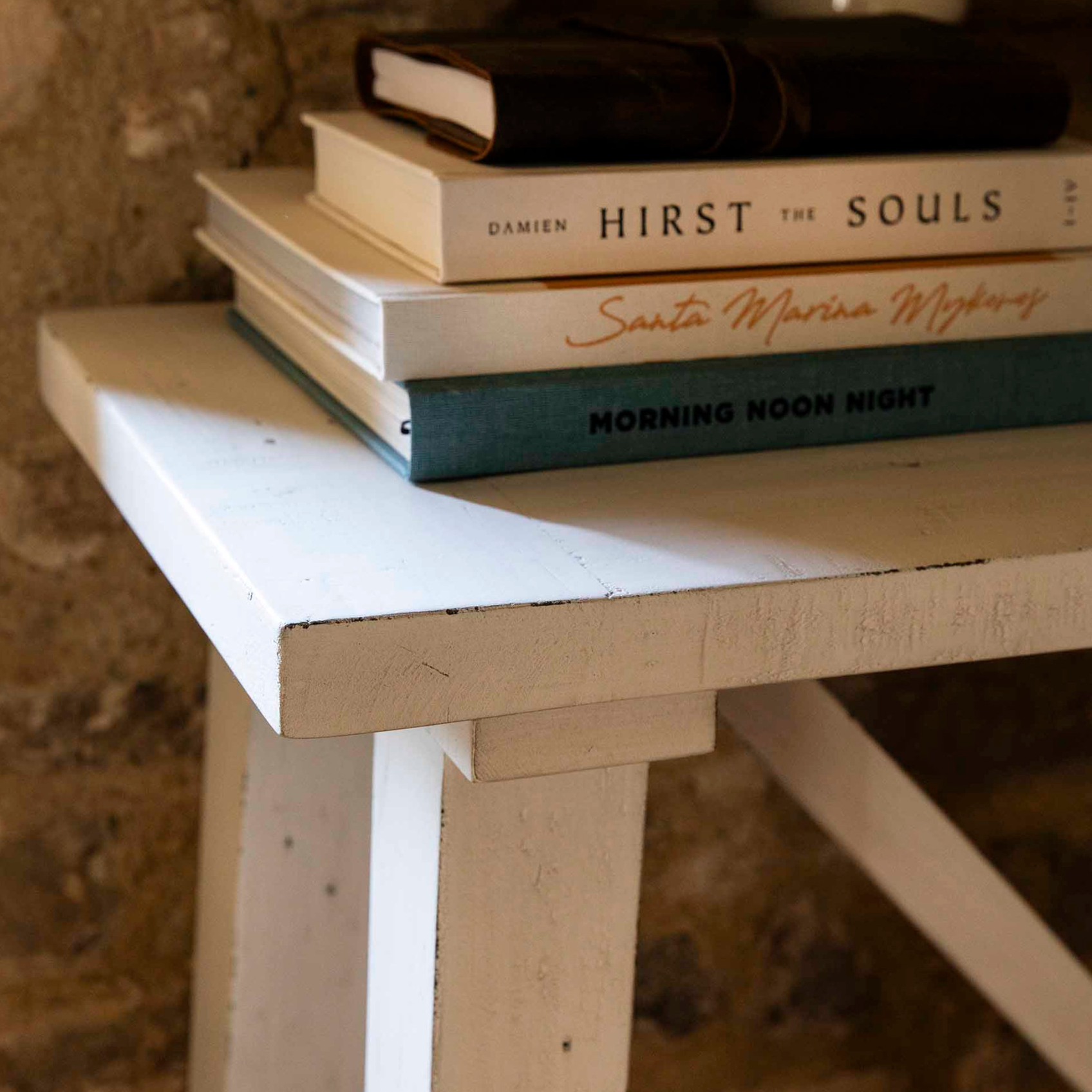 Detailed shot of a reclaimed wooden console table with decor books. 