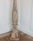 Close up of bottom of wooden floor lamp. 