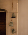 Rustic 3 bell garland, hanging from a mantelpiece with jute rope.