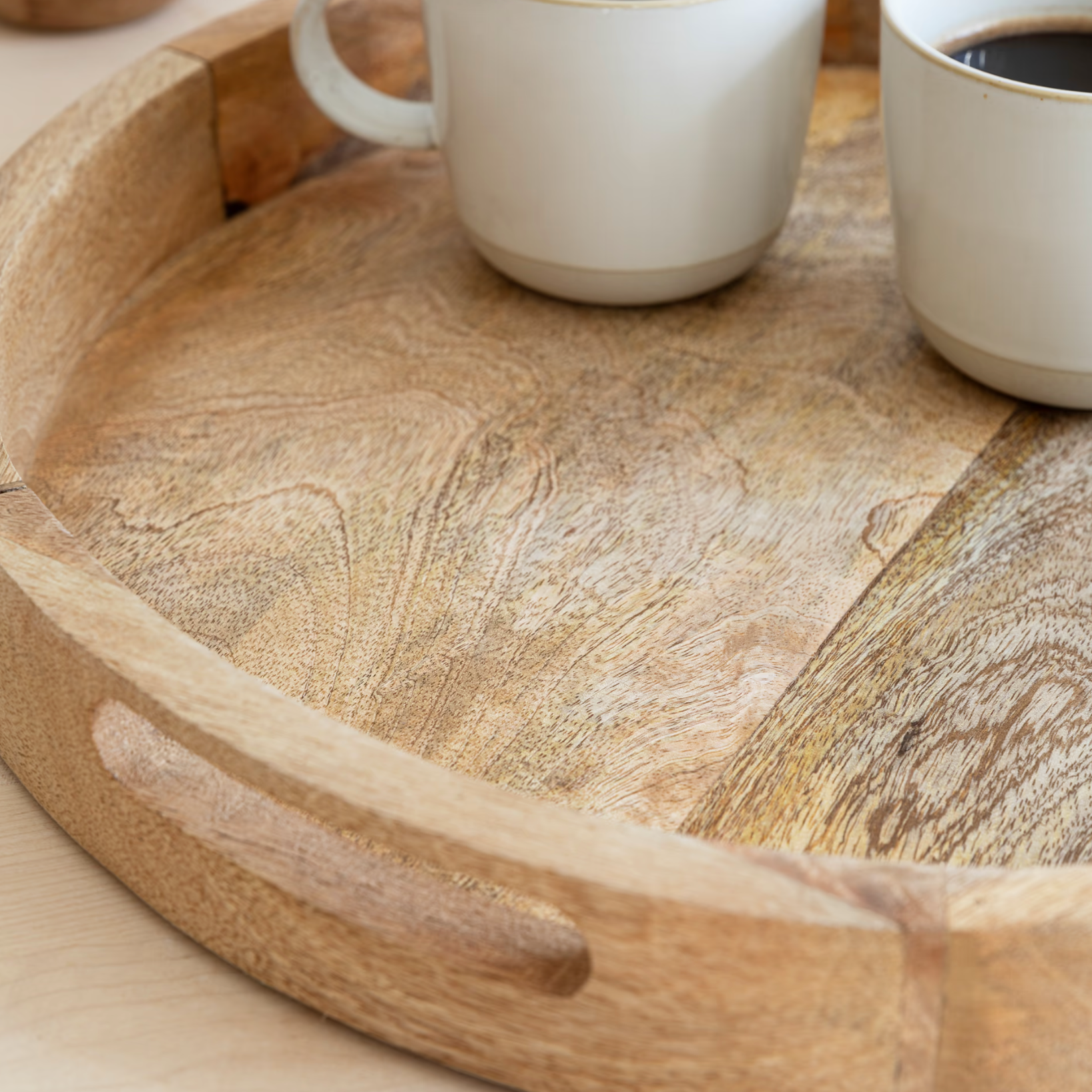 Round Wooden mango wood tray with cream mugs.