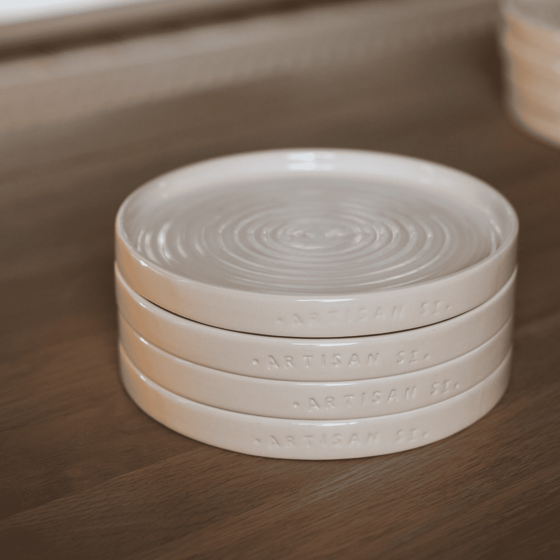 Stack of Side Plates on wooden table.