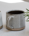 a brown speckled stoneware mug.