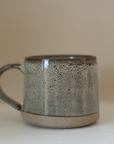 A brown speckled stoneware mug.