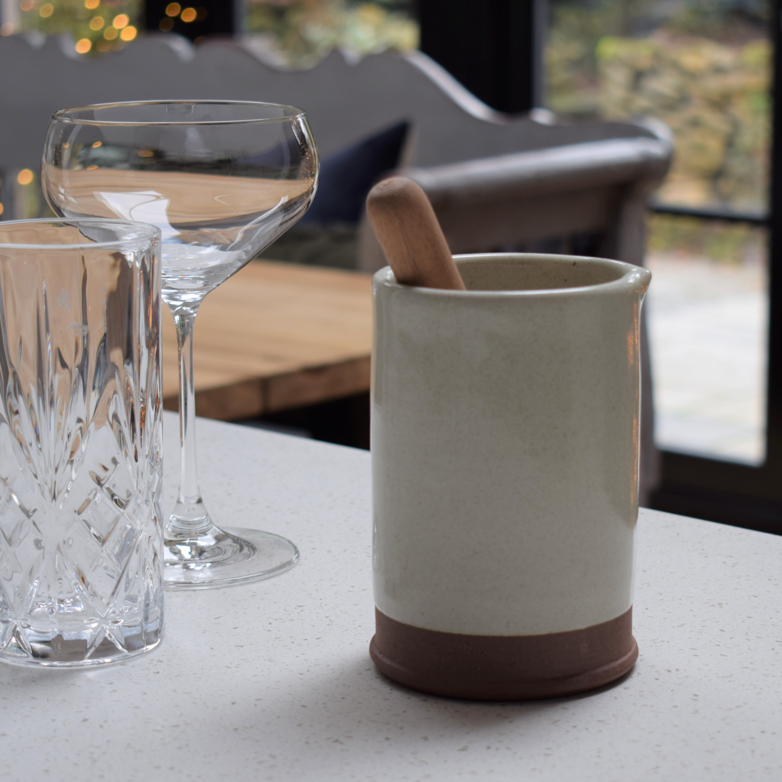 A white stoneware cocktail gift set with cut glasses.