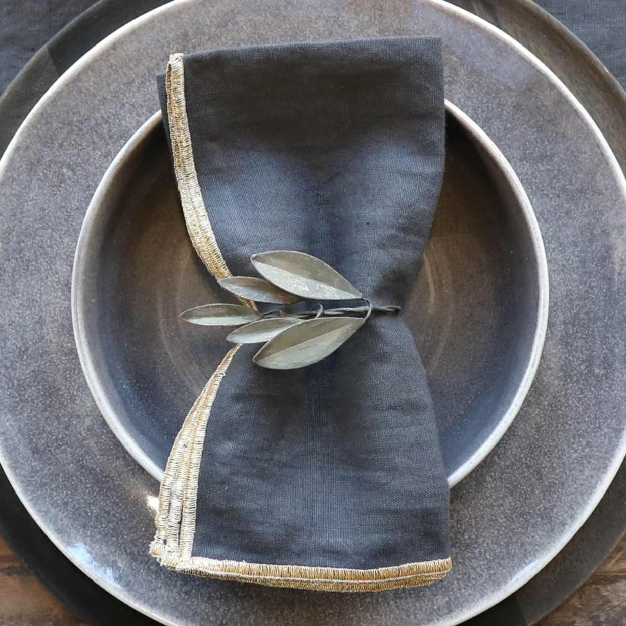 Grey table setting with rustic leaf napkin ring.
