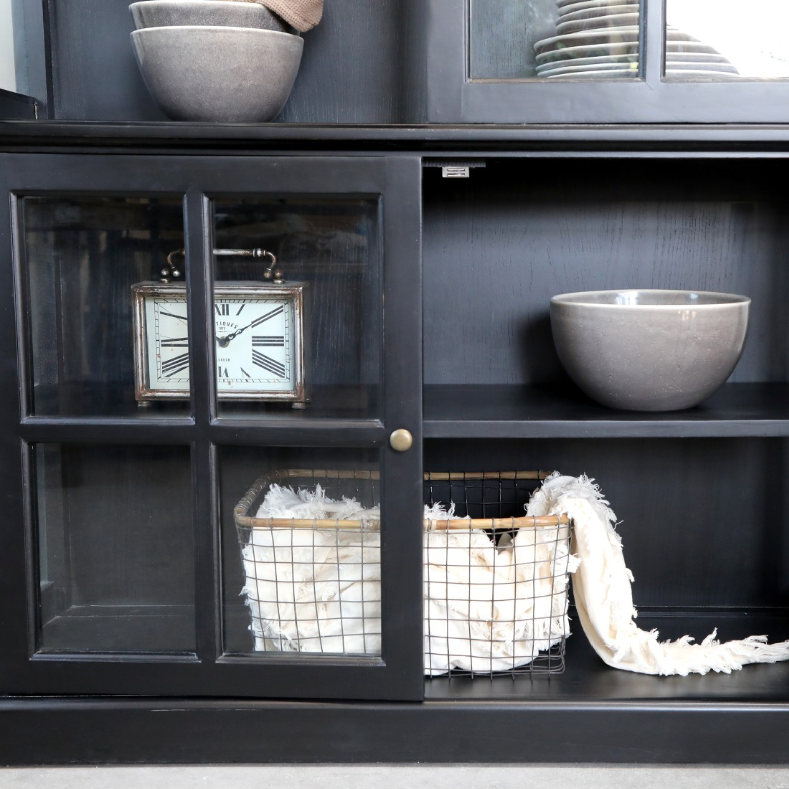 Black Armoire displaying home items.