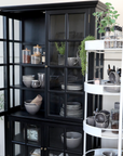 Black Armoire displaying crockery.