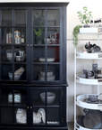 Black Armoire displaying crockery.