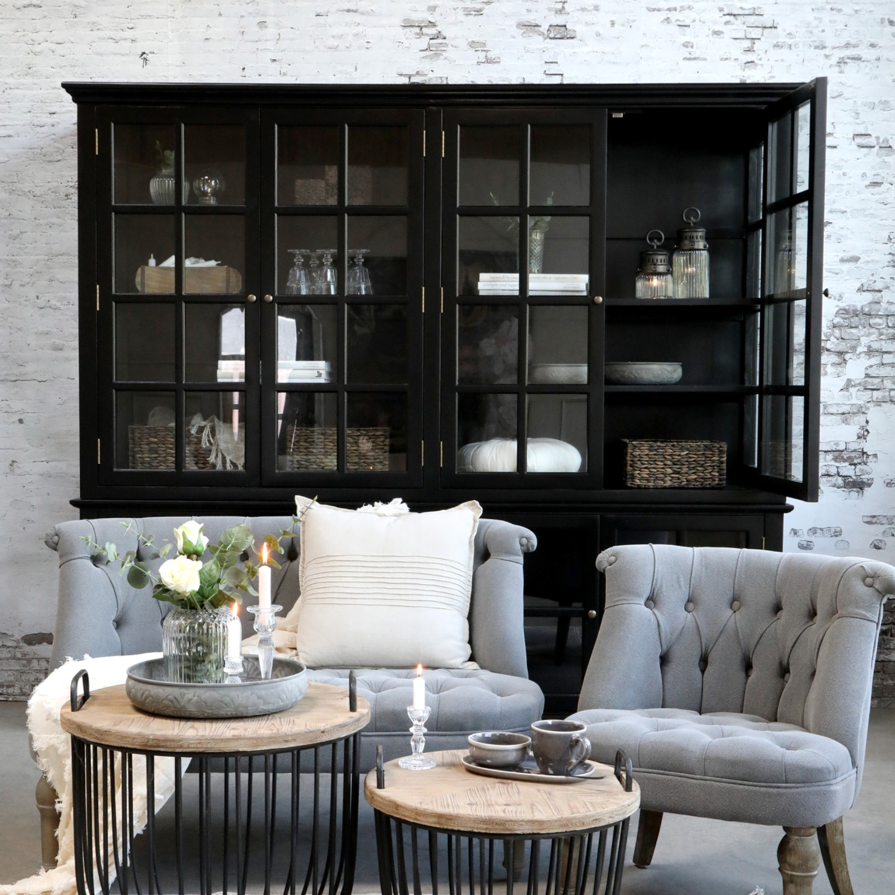 a relaxed seating area with large black armoire in background.