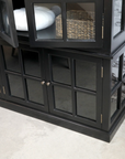 large black armoire with basket and cushion.