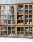 large wooden armoire displaying crockery and kitchen items. 