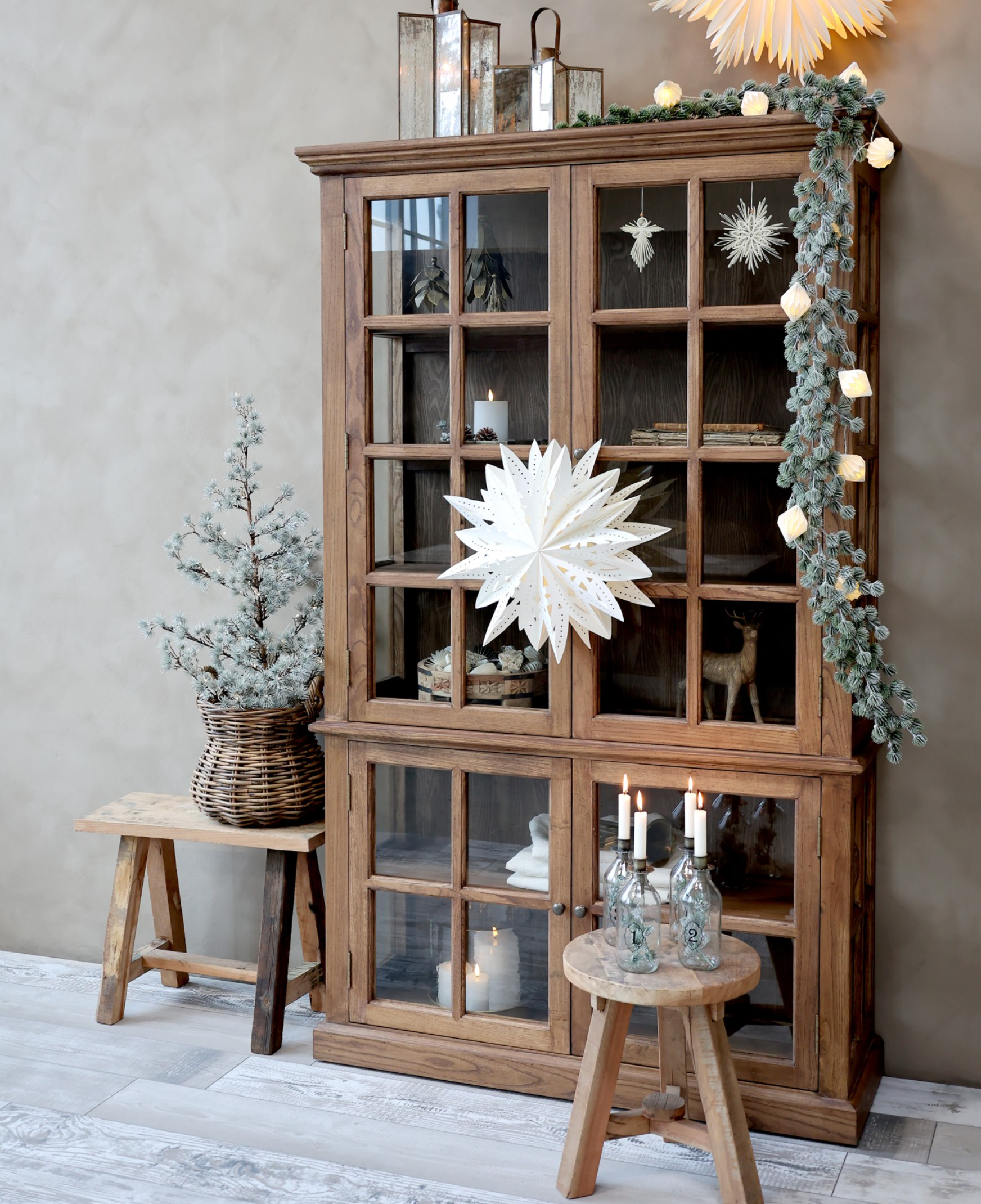 a natural wood toned armoire decorated for Christmas.