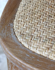 wicker seat on a wooden bar stool. 