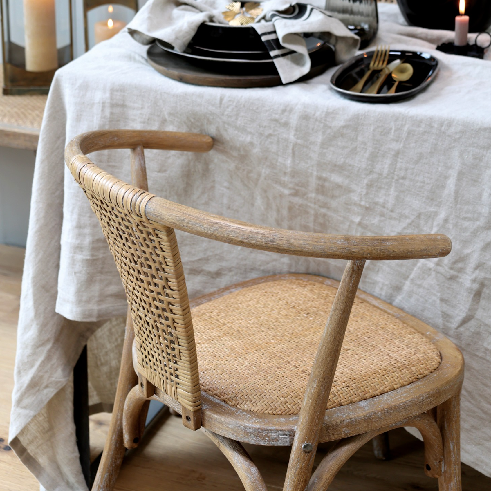 wicker backed dining chairs at table.